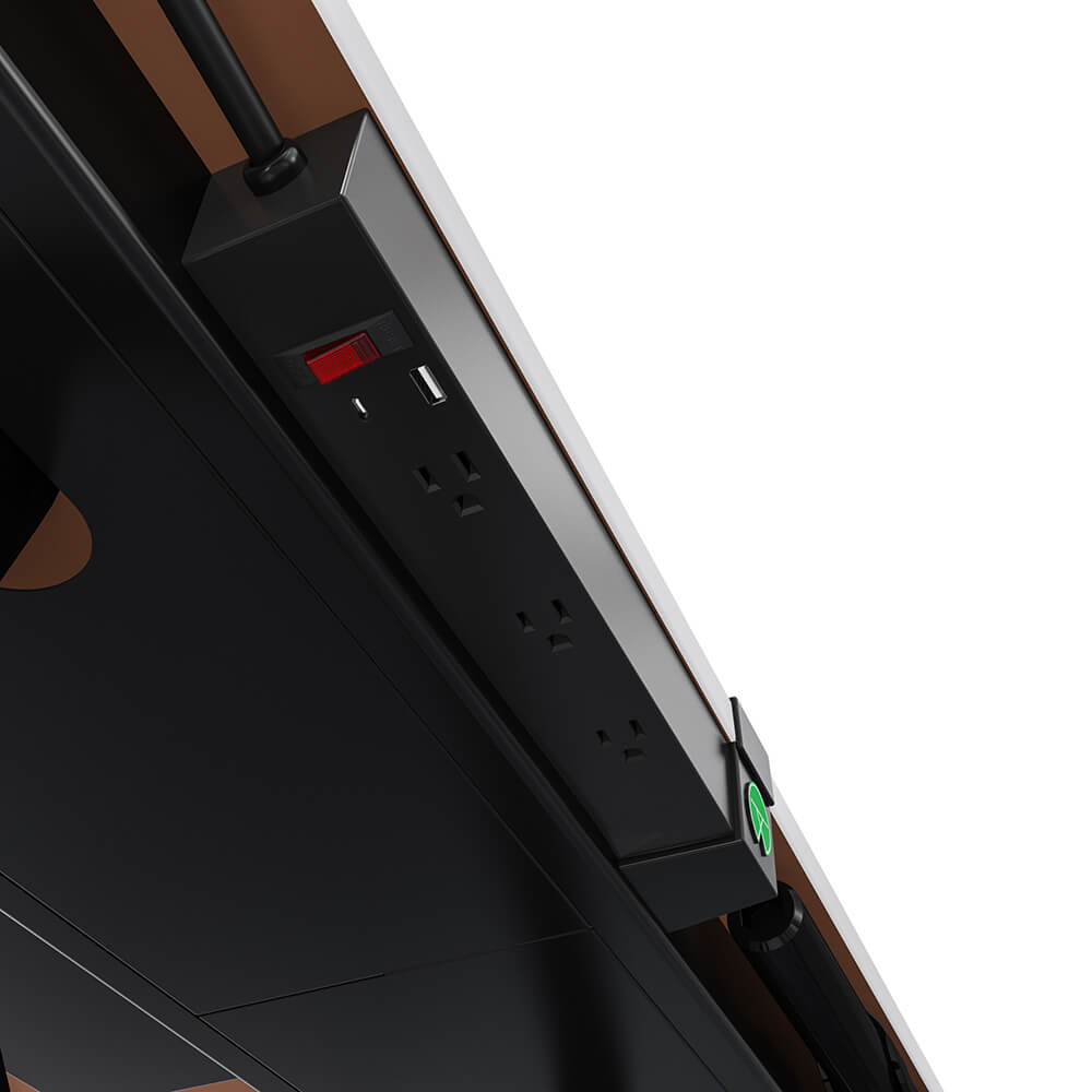 Standing desk cable management with a power strip mounted on the desk frame